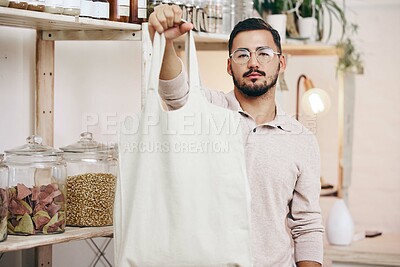 Man at eco friendly grocery store, fabric shopping bag and commitment to climate change at sustainable small business. Zero waste, plastic kills logo and supermarket with carbon footprint choice.