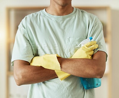 Man, hands and spray bottle in housekeeping, cleaning or bacteria and germ removal at home. Closeup of male person, maid or cleaner with arms crossed of professional in domestic service at house