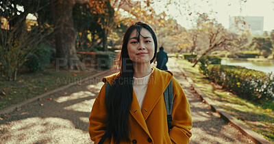 Buy stock photo Japanese woman, portrait and happiness in city in park with autumn leaves and wellness on holiday. Person, smile and face with confidence on path, summer vacation and tokyo town for leisure by trees