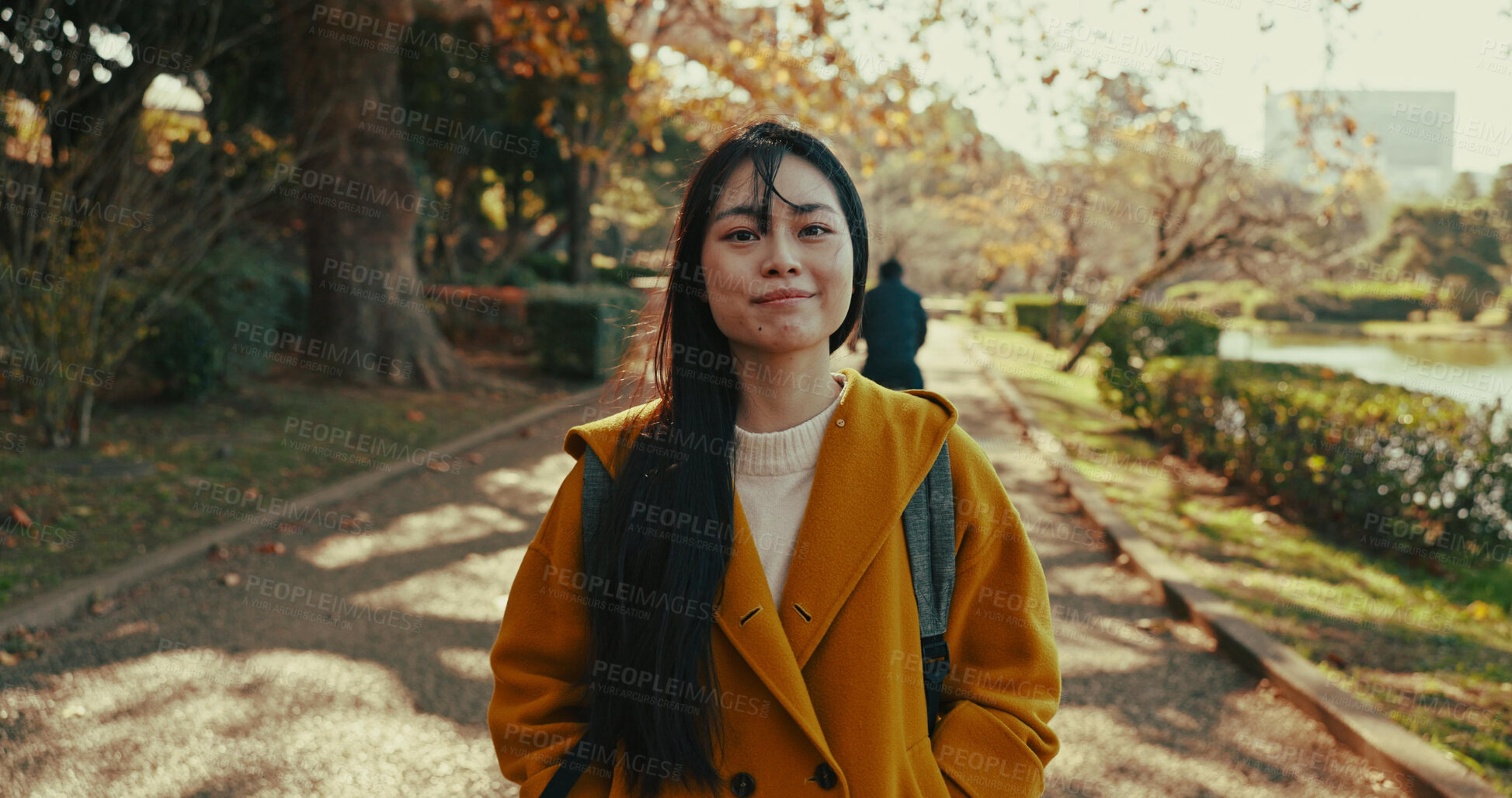 Buy stock photo Japanese woman, portrait and happiness in city in park with autumn leaves and wellness on holiday. Person, smile and face with confidence on path, summer vacation and tokyo town for leisure by trees