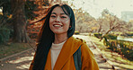 Japanese, portrait and woman with smile in park for travel on vacation, adventure and explore path with trees. Gen z, student and happy walk on holiday in nature, forest and trail in Kyoto woods