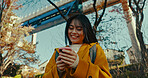 Japanese woman at train with phone, typing and reading online chat on morning commute. Search, schedule and travel, Asian girl on street checking email or post on smartphone app on journey in Tokyo.