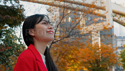 Buy stock photo Japanese woman, thinking and outdoor in city for travel in autumn with trees and happiness. Park, forest and person in Tokyo nature on commute in morning with freedom, wellness and adventure in woods