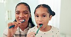 Brushing teeth, mother and daughter with toothbrush and dental for health, morning routine and happy face. Healthy, hygiene and portrait, woman and young girl, oral care and cleaning mouth at home