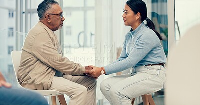 Support, psychologist or old man holding hands for comfort, empathy or compassion while sitting together. Trust, sympathy or therapist listening, talking or healing a loss with person in counseling
