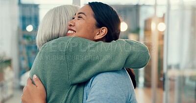 Senior woman, hug and visit of an old friend at a business office with a smile. Elderly female person, love and happy women together at a workplace with support and care from staff at physiotherapy