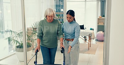 Woman, nurse and patient with walker in elderly care for physiotherapy or walking at the clinic. Female physiotherapist or caregiver assisting senior client or person with a disability in retirement