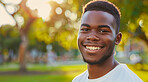 Young, man and portrait of a male laughing in a park for peace, contentment and vitality. Happy, smiling and confident african boy radiating positivity outdoors for peace, happiness and exploration