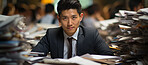 Asian man, portrait and business person sitting in busy office, conference room or studio. Pile of documents, files and corporate background for administration, company and work in modern times