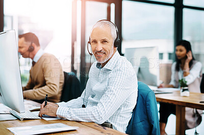 Buy stock photo Cropped portrait of a handsome mature male operator working at his desk