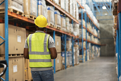 Warehouse, factory and back view of employee with stock, inventory and cargo for logistics management company. Industrial, worker and man in supply chain for shipping, freight and e commerce
