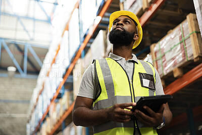 Warehouse, engineer and black man with tablet for planning storage, distribution or check stock of freight. Factory, technology and serious worker thinking of shipping, inventory and cargo on app