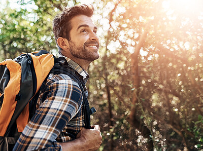 Buy stock photo Cropped shot of a handsome young man hiking in the mountains