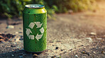 Recycle, sign and eco friendly can on the ground for environmental, awareness and sustainability concept. Green, recycling and aluminium with copyspace for Earth Day, eco system or ecology logo