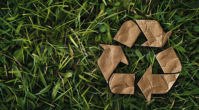 Recycle, sign and cardboard on nature background for environmental, awareness and sustainability concept. Green grass, mockup and symbol with copyspace for Earth Day, eco system and ecology logo