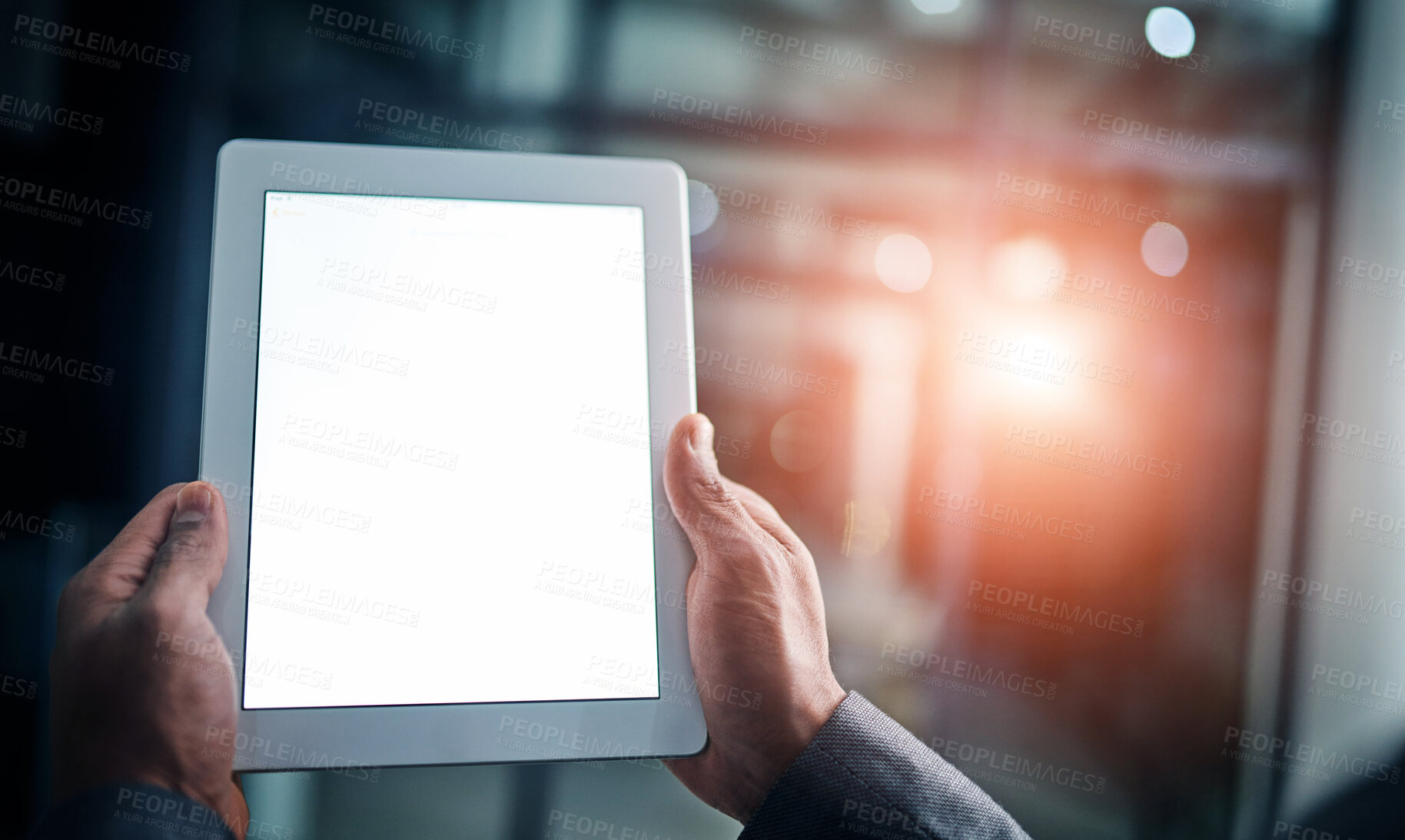 Buy stock photo Man holding tablet in hand with blank screen over a isolated copy space background. Closeup of businessman hands on a digital tablet in a modern office working late at night.