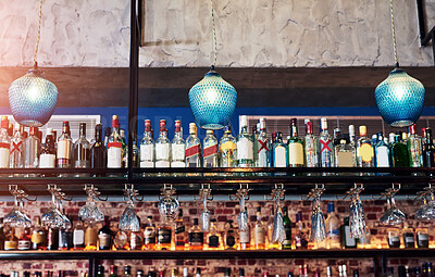 Buy stock photo Shot of an immaculate bar with many bottles and glasses with no people