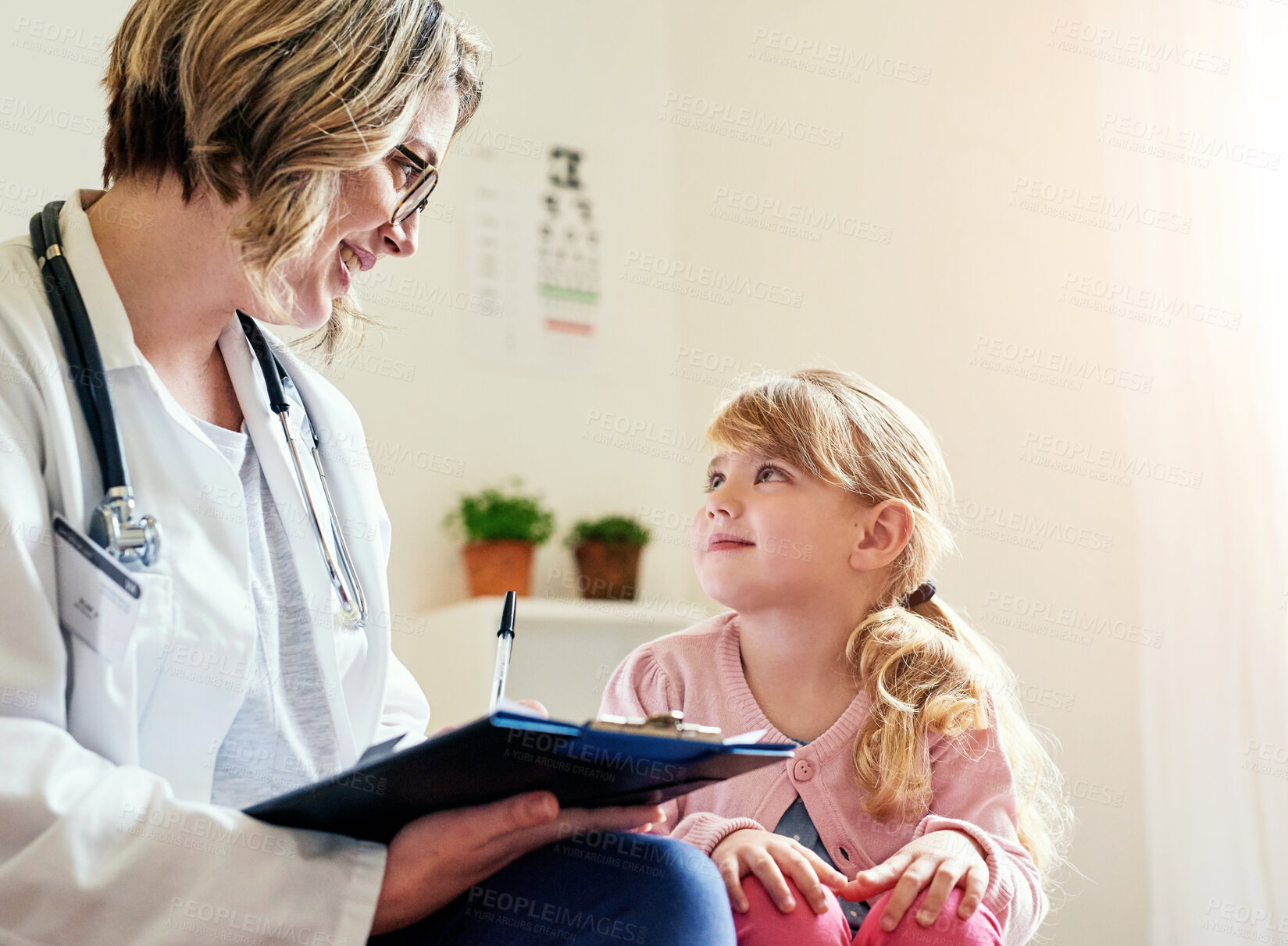 Buy stock photo Doctor, child and clinic consultation with clipboard, healthcare checkup and girl with medical professional. Woman, sickness diagnosis and wellness result, pediatrician and treatment or patient chart