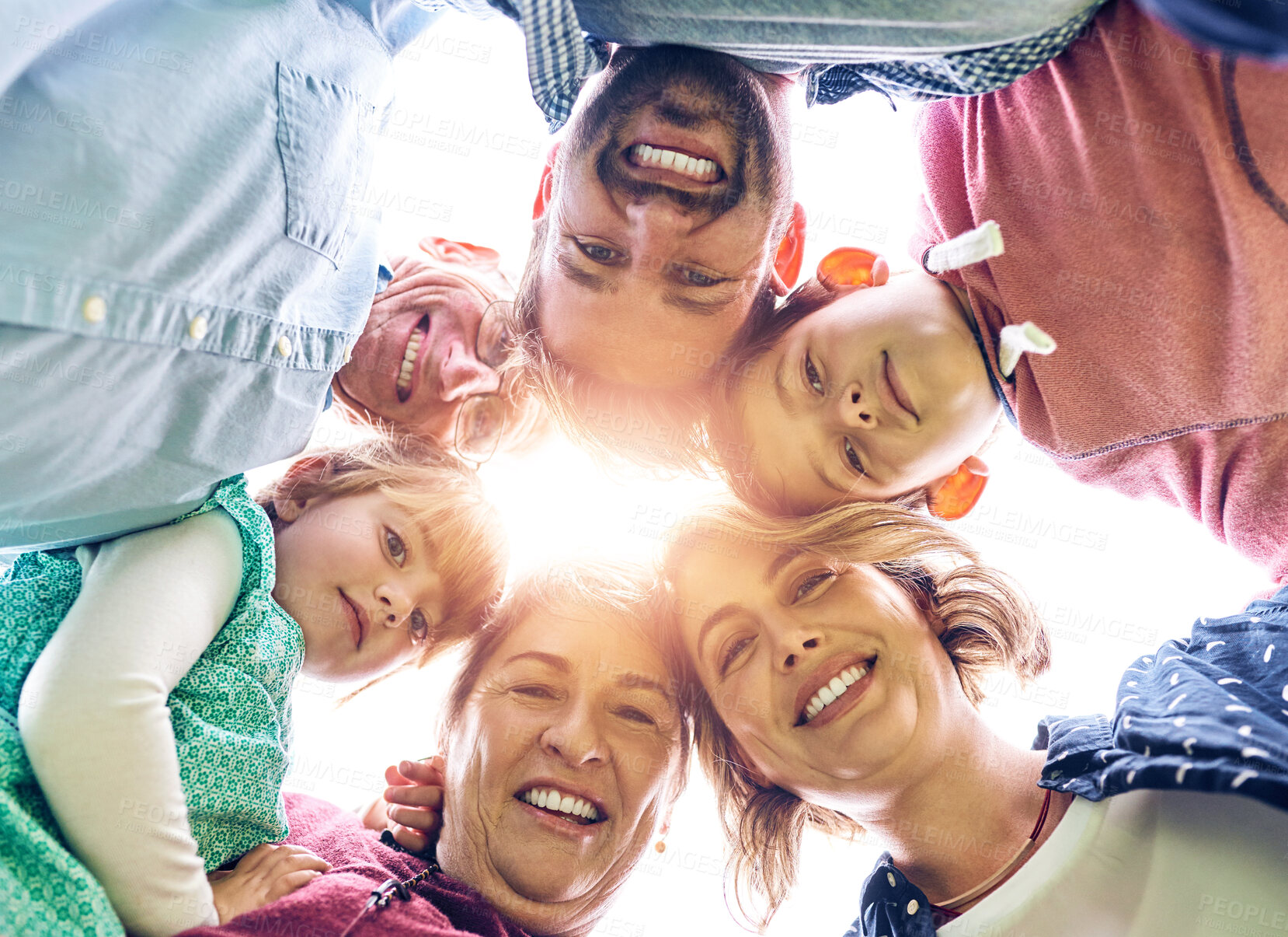 Buy stock photo Low angle shot of a multigenerational family outside