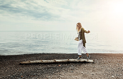 Buy stock photo Tree trunk, seaside and woman walking with balance, relax and vacation for stress relief, journey or play. Person, beach and girl with weekend break, ocean or adventure with nature, travel or holiday