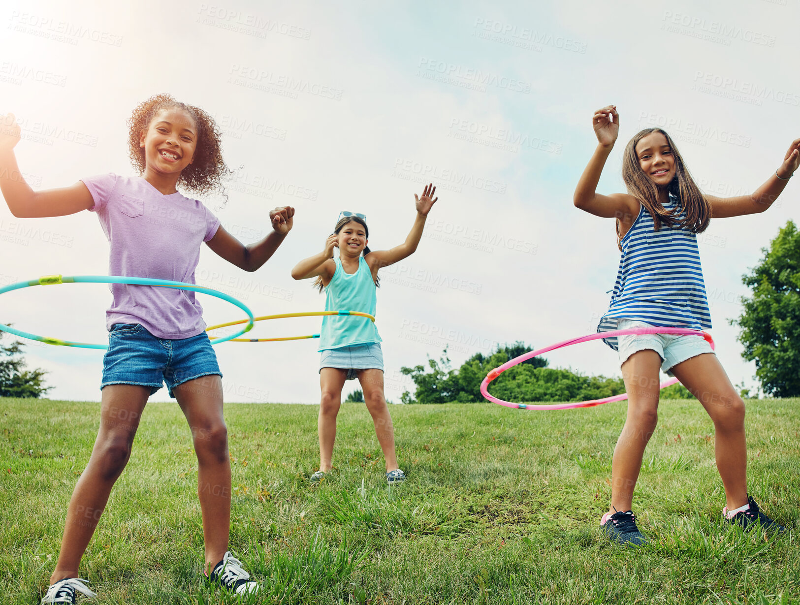 Buy stock photo Portrait, hula hoop and children in park, girls and happiness with weekend break, bonding together and playful. Kids, outdoor or friends with recreation, game or cheerful with fun, summer or leisure