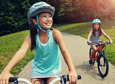 Buy stock photo Outdoor, park and children with bicycle for riding, learning and playing together with helmet for safety. Nature, path and  happy girls for cycling, bike activity and coordination with balance