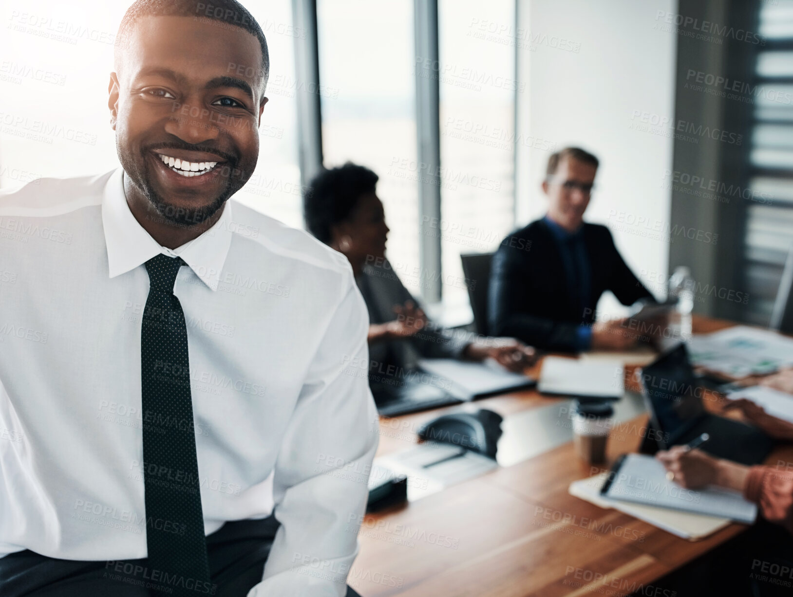 Buy stock photo Business meeting, portrait and happy black man in office with team for planning, research or discussion. Corporate, conference or manager face at agency for group collaboration, solution or feedback