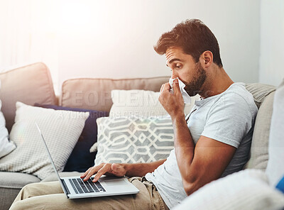 Buy stock photo Remote work, laptop and sick man on sofa blowing nose with toilet paper, allergies or influenza in his home. Freelance, burnout or telework consultant with tissue for bacteria, infection or virus
