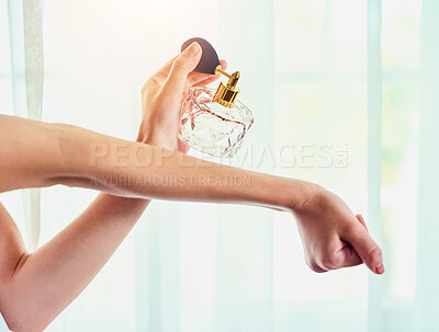 Buy stock photo Closeup shot of an unrecognizable woman applying perfume to her wrists