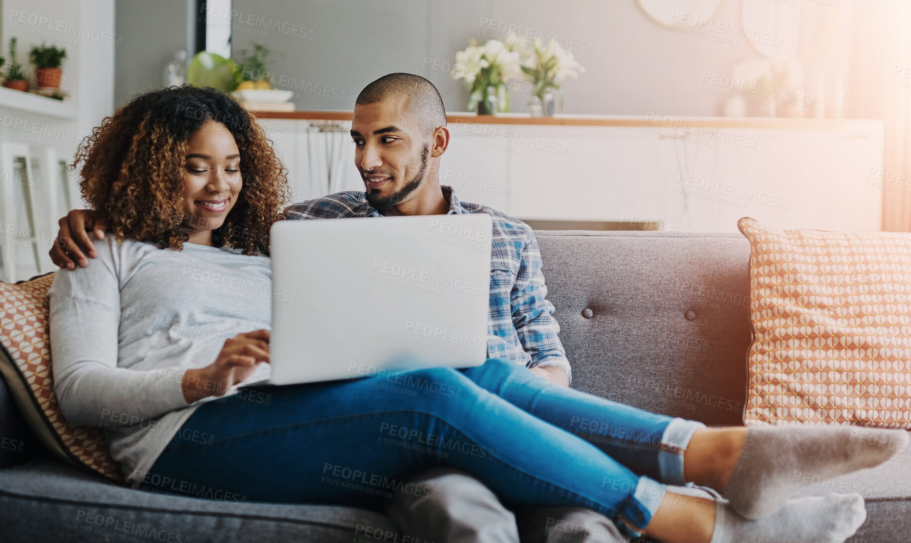 Buy stock photo Happy, relaxed and carefree couple bonding together on the sofa in the living room at home. Loving, affectionate and smiling boyfriend and girlfriend relaxing, typing and browsing on a laptop