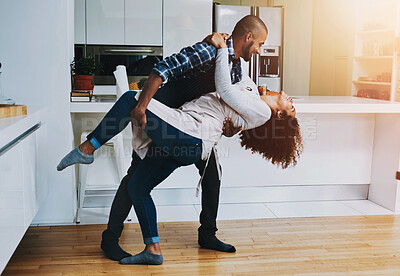 Buy stock photo Shot of a young couple dancing at home