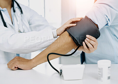 Buy stock photo Closeup shot of a doctor checking a patient's blood pressure in a hospital