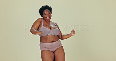 Buy stock photo Dancing, body positivity and portrait of black woman in underwear, studio and self love for celebration. Happy, smile and face of young plus size female model, dance or confidence on green background