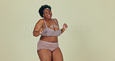 Dancing, body positivity and face of black woman in underwear in a studio for self love celebration. Happy, smile and portrait of young African female model moving with confidence by green background