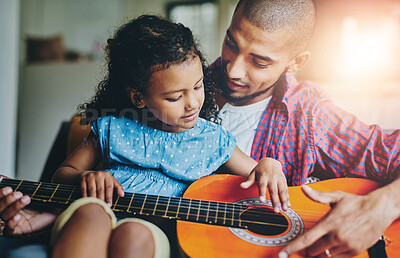 Buy stock photo Guitar, music or teaching with father and girl child in home living room together for bonding. Happy, instrument or love with single parent man and daughter in apartment for development or learning