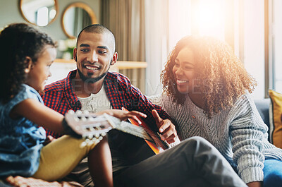 Buy stock photo Guitar, happy and teaching with family in home living room together for bonding. Love, music or smile with mother, father and daughter having fun in apartment for development, learning or lesson