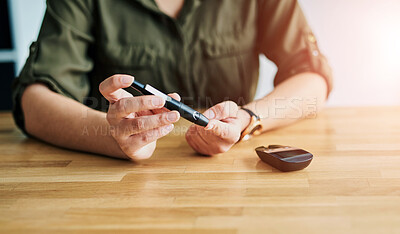 Buy stock photo Closeup shot of an unidentifiable businesswoman testing her blood sugar level in an office