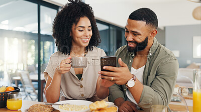 Couple, happy and coffee with smartphone for social media, sharing music or app explanation. Man, woman and technology in kitchen with breakfast for morning, relaxing and scrolling on online website