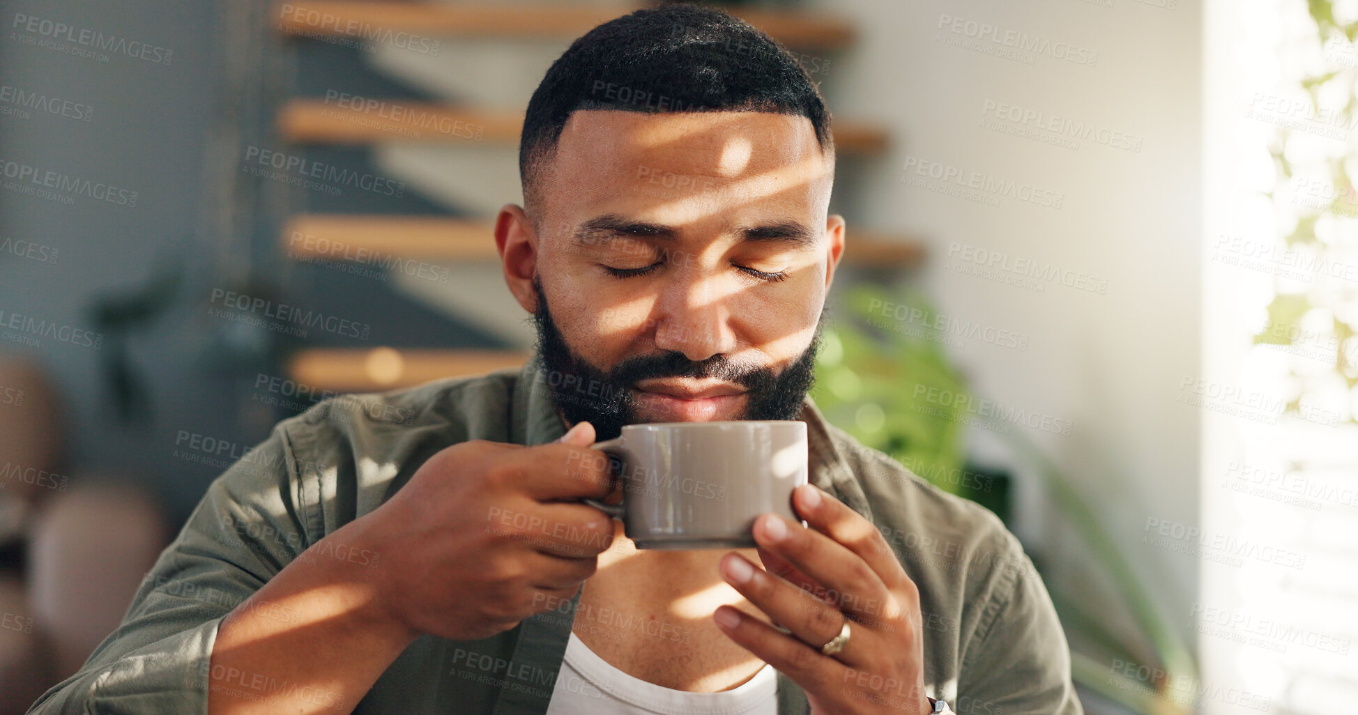 Buy stock photo Smile, calm and man with coffee by window in apartment for relaxing weekend morning routine. Happy, peace and young male person drinking cappuccino, tea or latte in cup with aroma at modern home.