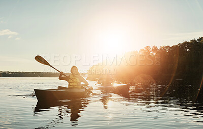 Buy stock photo Couple, boat and ocean with sunset for canoeing, travel or holiday on outdoor journey in water, lake or nature. Man and woman enjoying ride or paddle in sunshine at sea for rowing, kayak or adventure