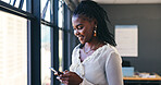 Phone, networking and professional black woman in the office browsing on social media or the internet. Smile, technology and African female person scroll on mobile app with cellphone in workplace.