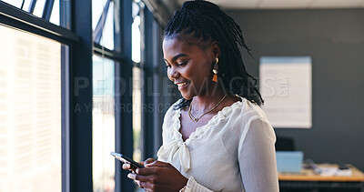 Phone, networking and professional black woman in the office browsing on social media or the internet. Smile, technology and African female person scroll on mobile app with cellphone in workplace.