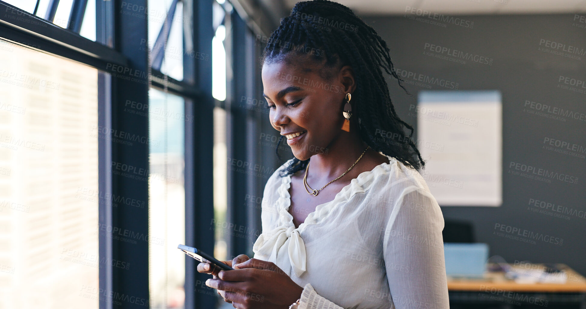 Buy stock photo Phone, networking and professional black woman in the office browsing on social media or the internet. Smile, technology and African female person scroll on mobile app with cellphone in workplace.