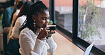 Coffee shop, relax and black woman by window with drink for happiness, calm and breakfast in cafe. Restaurant, weekend and happy person with mug, aroma and scent for latte, caffeine and cappuccino