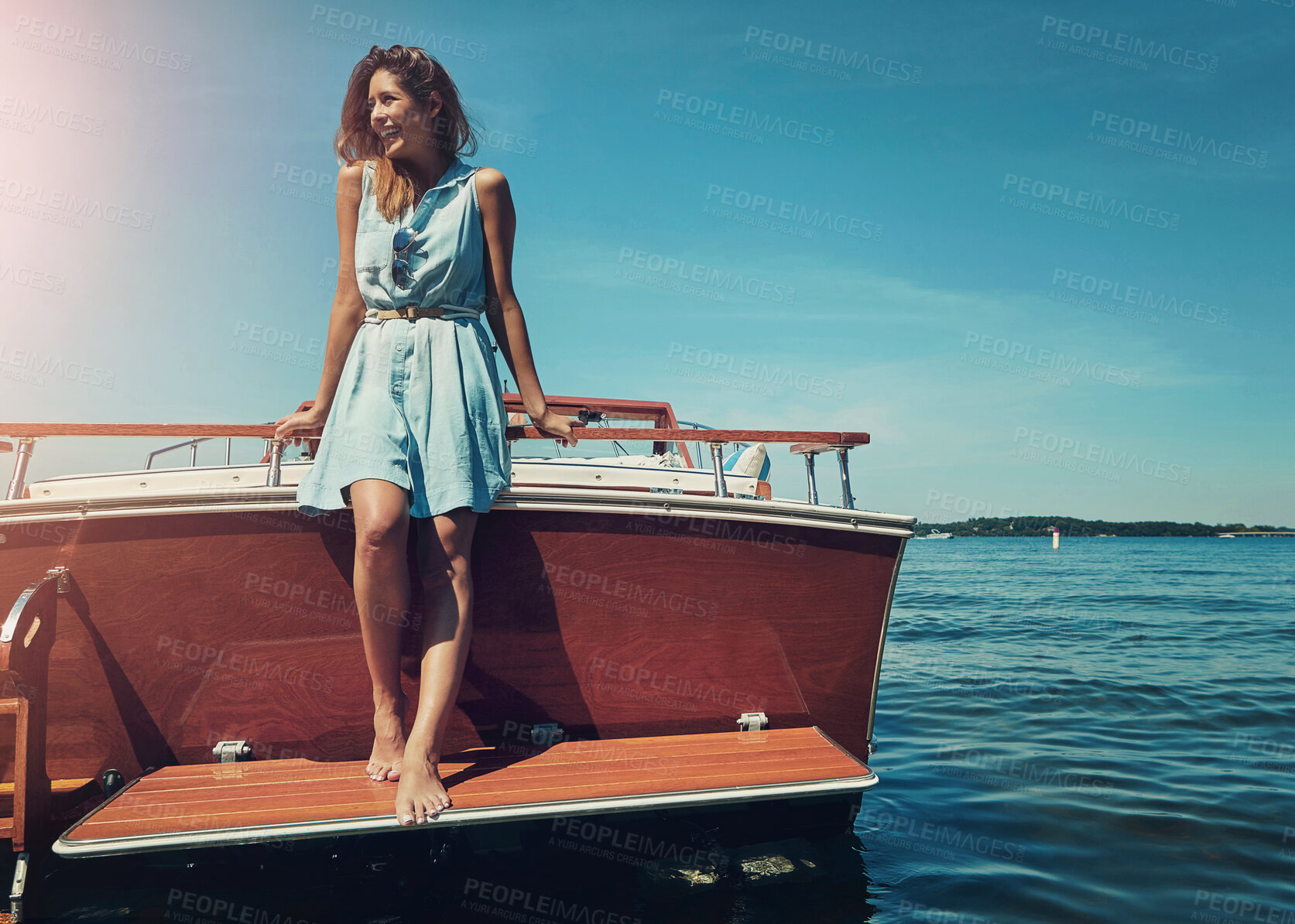 Buy stock photo Blue sky, standing and woman on boat for travel, vacation or holiday by ocean with adventure. Happy, explore and female person on deck of yacht by sea water for tropical summer weekend trip in Italy.