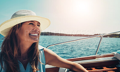 Buy stock photo Cropped shot of an attractive young woman sitting at the back of a yacht on the open seas