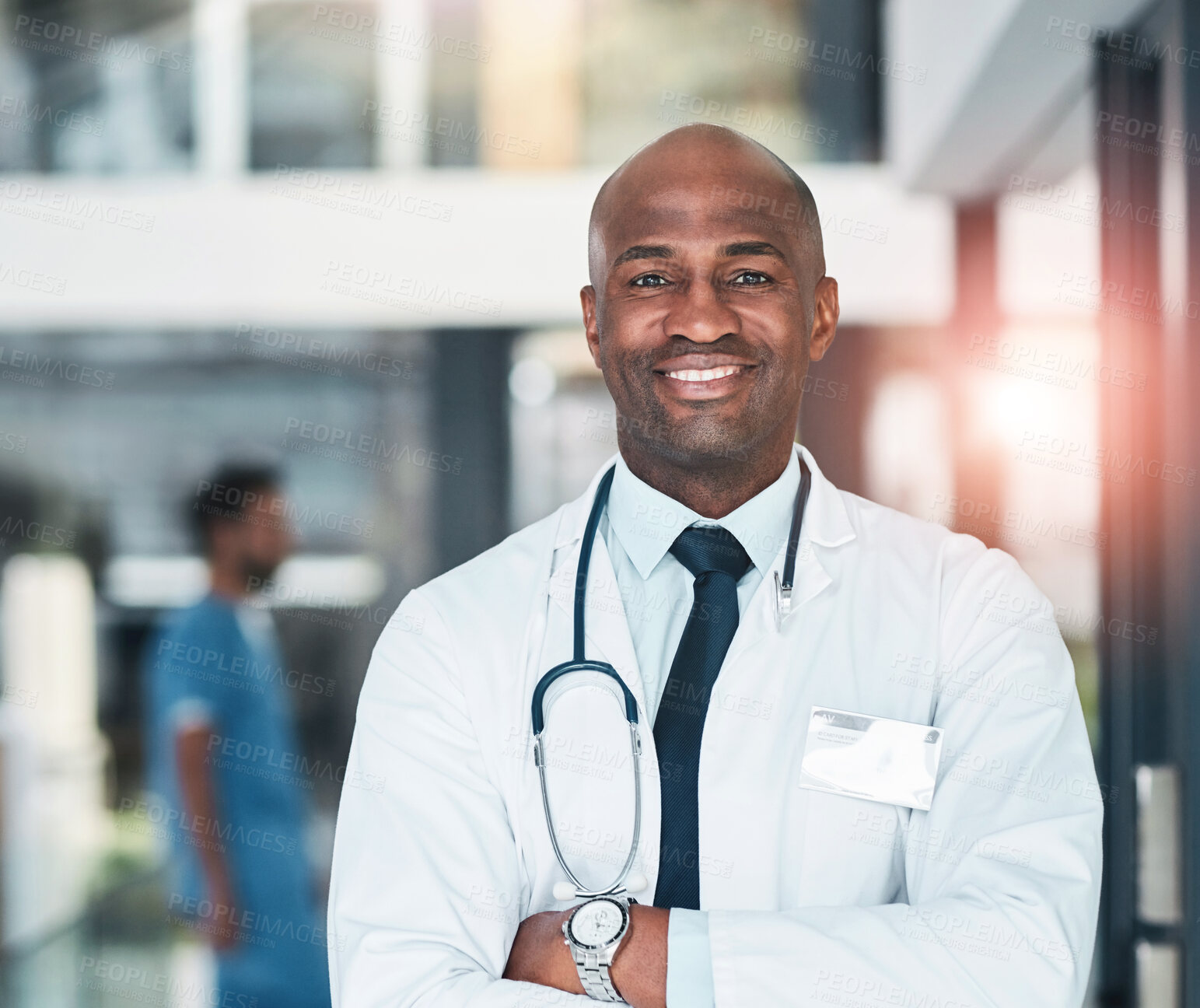 Buy stock photo Healthcare, portrait and man doctor with arms crossed at hospital for help, treatment and service pride. Face, smile and African health expert with stethoscope for cardiovascular, consulting or exam