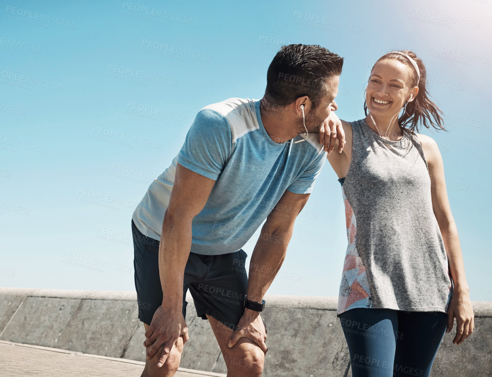 Buy stock photo Cropped shot of a young couple out for a run on the promenade