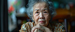 Portrait, elderly Asian and woman close-up. Senior, female and thoughtful in old age home. Pensioner, depressed and looking. Blurry background for mental health and reminiscing about past life