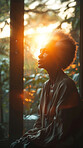 Meditate, elderly African and woman with plants. Senior, retirement and spiritual health in room with large window. Thinking, thoughtful and praying in sunset for worship and lifestyle concept